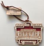 Product Description: Celebrate the legacy of the Carnegie Library this holiday. These eco-friendlylaser-cut ornaments use wood that is sustainably sourced and 100% compliant with the Lacey Act USA. They are custom designed and created by a Small, Woman-owned, business (SWAM) in the USA. </br></br>Material: Baltic Birch Plywood is sustainably sourced and 100% in compliance with the Lacey Act USA</br>Dimensions: 3 x 3.5 inches</br> Carnegie Ornament